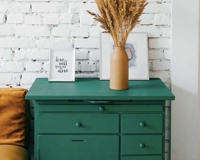 Image of a green drawer next to a bed